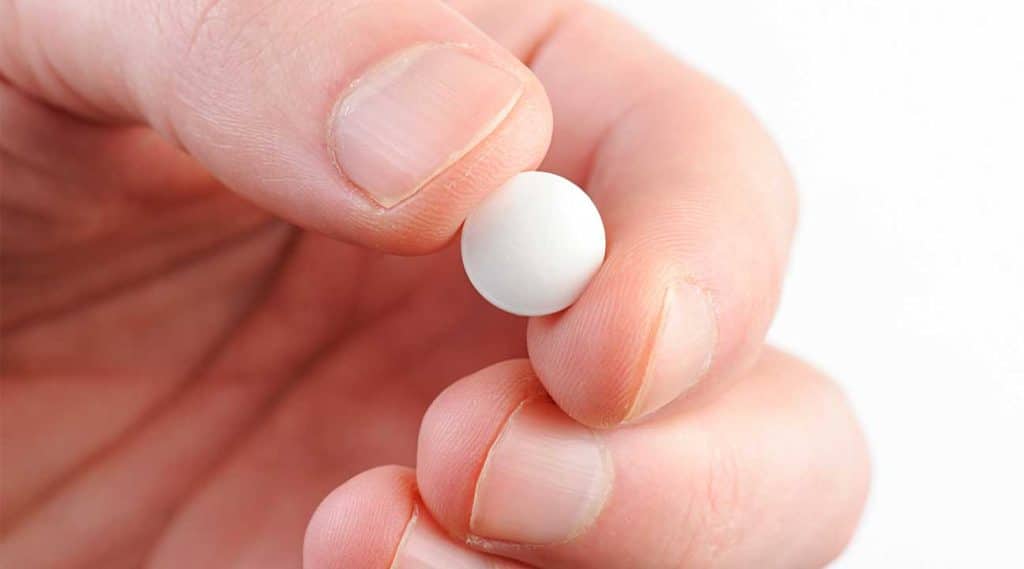 woman holding a white pill Concerta