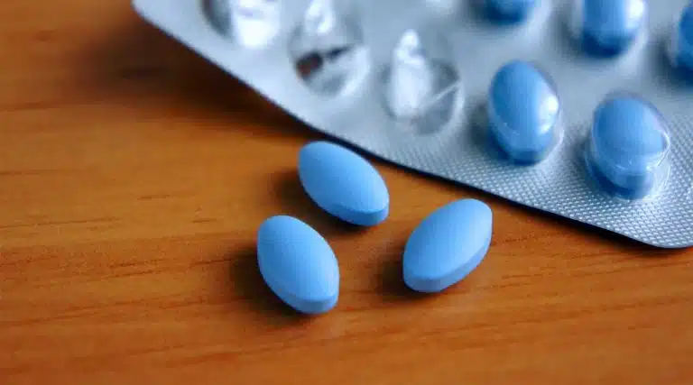 blue Halcion (Triazolam) pills on a table next to empty blister packs