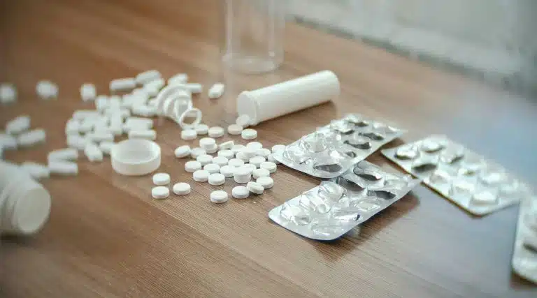 many Hydrocodone pills spilled and scattered across a table