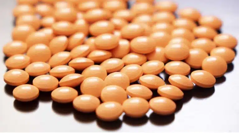 pile of orange pills Hysingla ER hydrocodone opioid pills medication