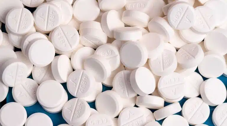 pile of white round oxycodone opioid pills