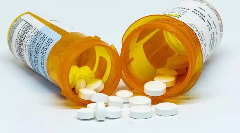 two bottles of prescription pills white pills Vicodin and Percocet