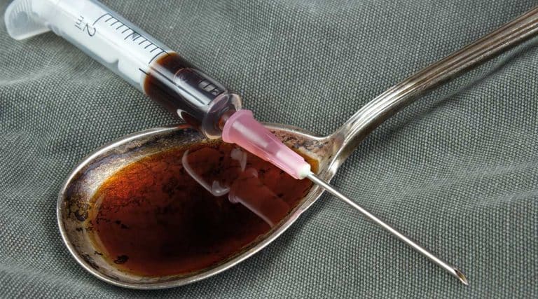 black tar heroin syringe and spoon