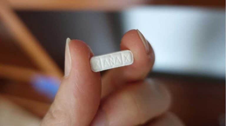 woman holding real xanax or fake xanax pills
