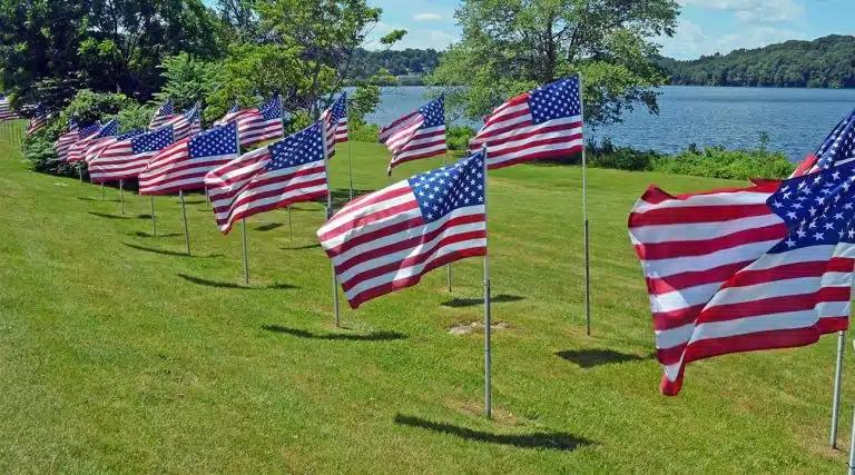 American flags on a hillside near a lake in Carmel, New York