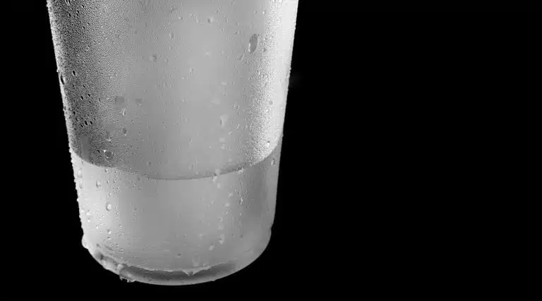 condensation on the outside of a cup filled with cold water for cold water extraction process