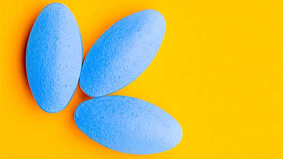 three blue pills on a yellow background - How Long Does Halcion Stay In Your System (Urine, Blood, Saliva, & Hair)?