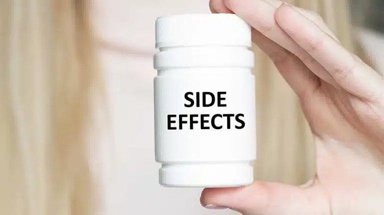 woman holding a pill bottle labeled side effects - Lexapro Side Effects In Women & Men
