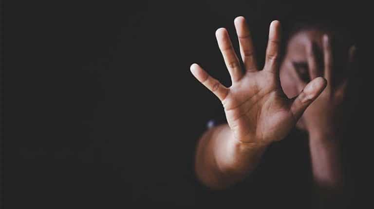 woman holding up her hand in fright - Substance Abuse And Domestic Violence: Facts And Getting Help