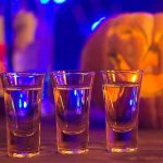 Jack-olntern and shot glasses - Halloween Drinking Statistics In The U.S.