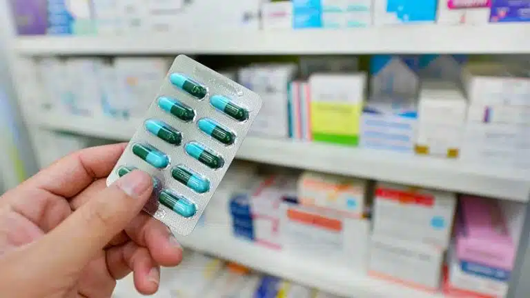 woman holding pills-Over-The-Counter Medications | List Of OTC Drugs