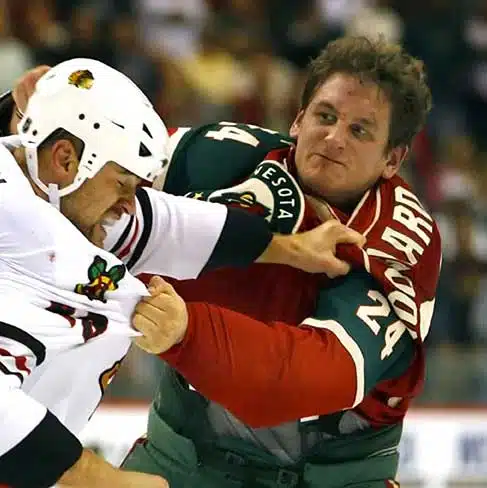 Derek Boogaard know as "The Boogeyman" during his days with the Minnesota Wild engages in a fight against an opponent.
