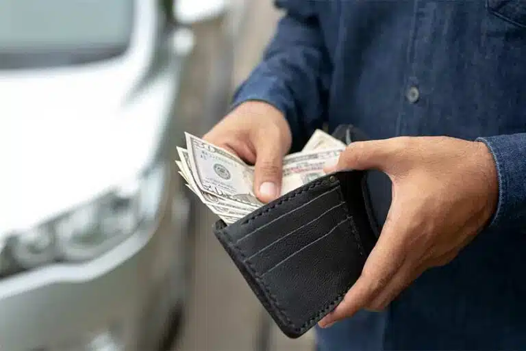 Man Getting Cash Out Of His Wallet-Will I Need Money During Drug & Alcohol Rehab?